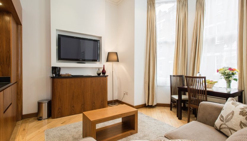 Deluxe Studio Apartment with bright living area and dining space at Presidential Apartments Kensington