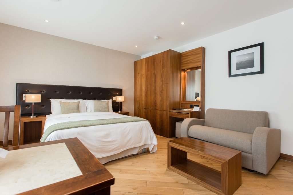 Studio apartment with double bed, sofa and wooden wardrobe, Presidential Serviced Apartments London