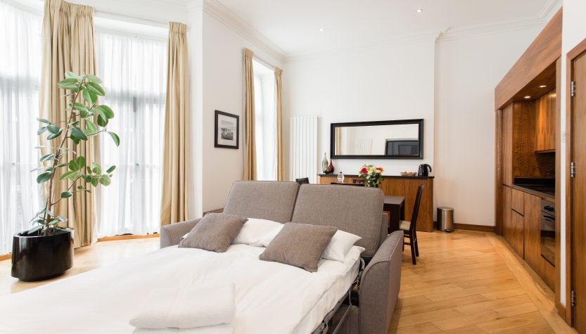 Presidential Suite with Balcony in Kensington London featuring bright living space and kitchenette at Presidential Apartments London