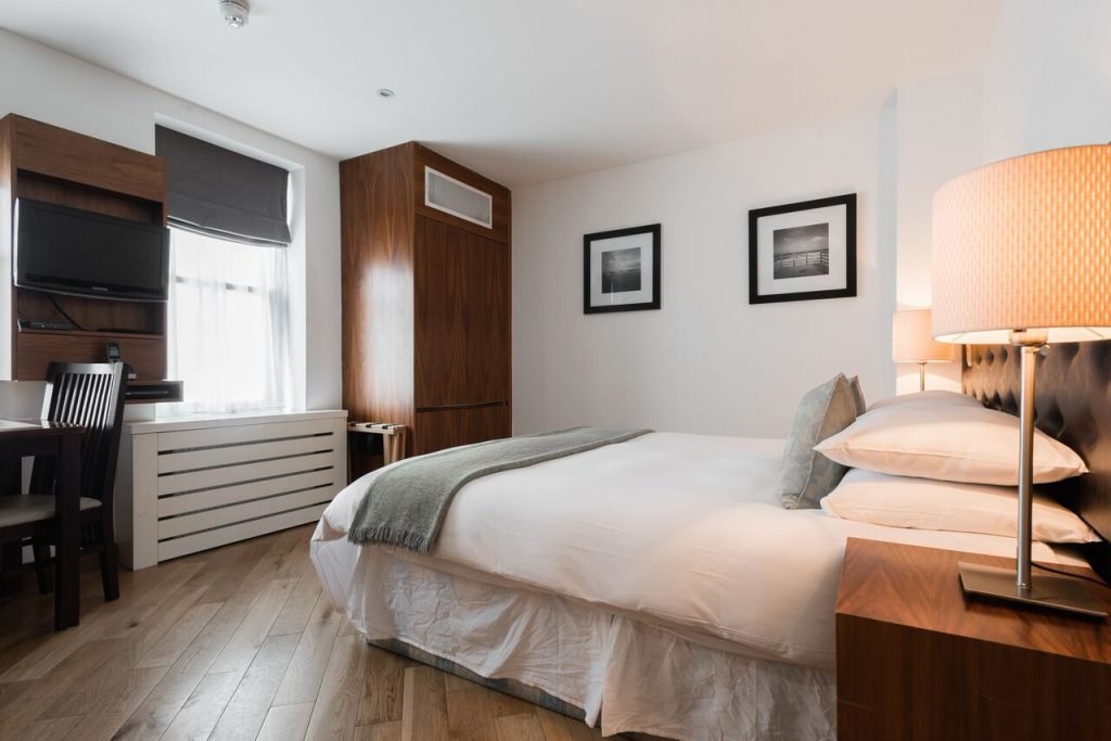 Standard Studio with a double bed, desk and wardrobe